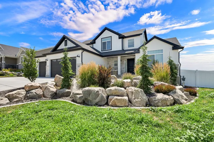 Contemporary home exterior with white siding and dark trim accents