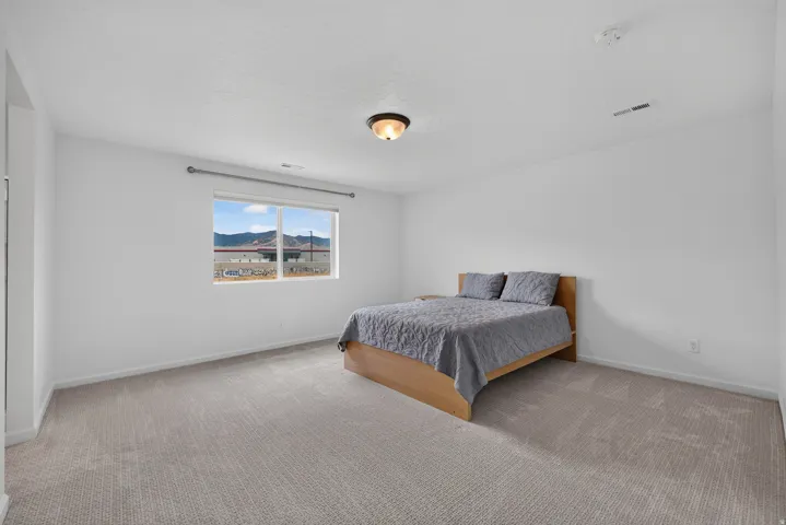Bright interior space with light gray wall paint and matching carpet flooring