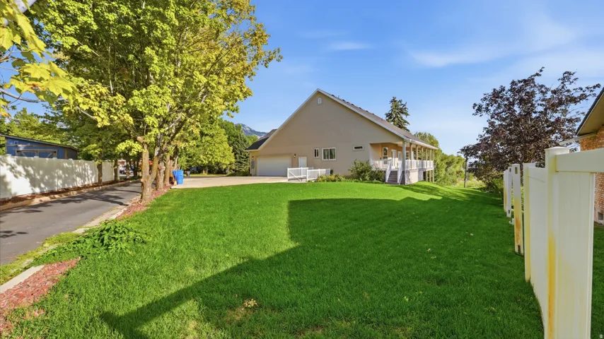 Expansive green lawn with a privacy fence