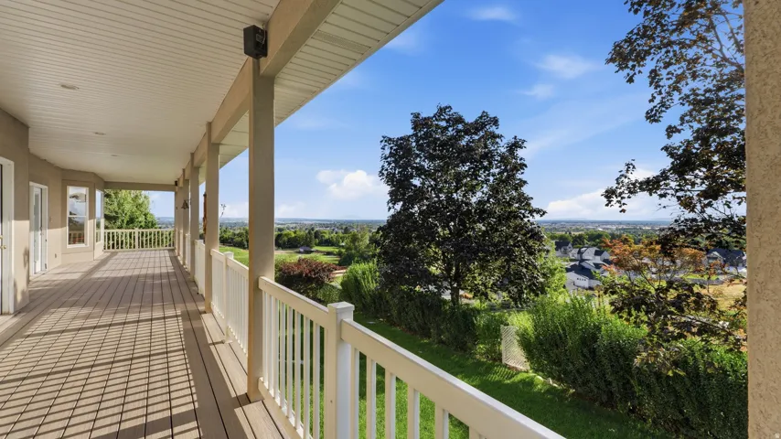 Expansive covered deck with composite decking and white railing