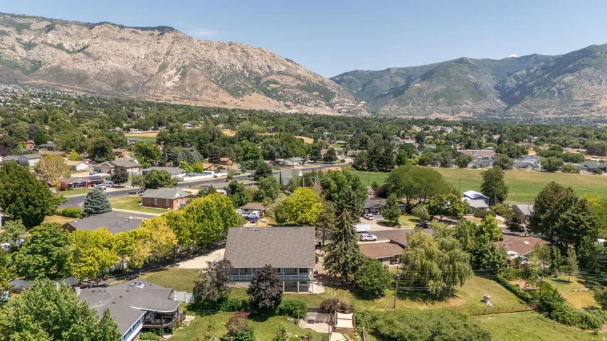 Aerial perspective showcasing a residential area framed by mountains