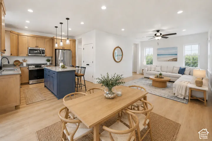 Open-concept living space featuring wood-finish flooring, recessed lighting, and ample natural light