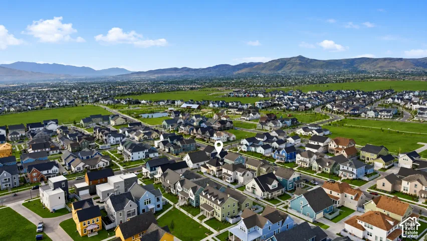 Expansive neighborhood featuring various residential structures, manicured green spaces, and paved roadways