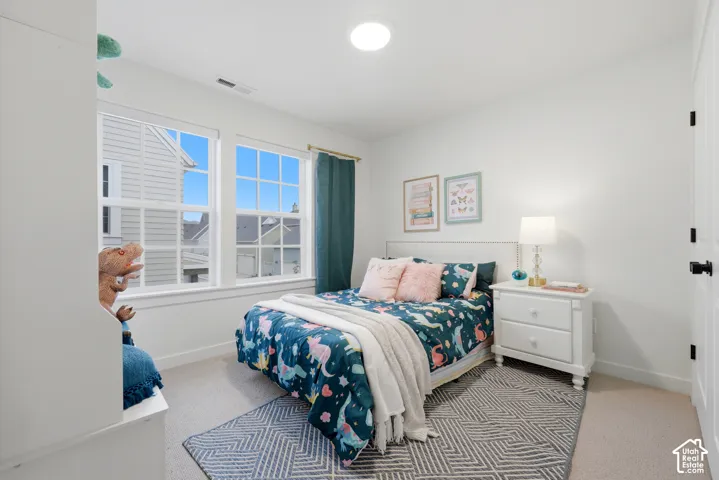 Light-filled room featuring two multi-pane windows, a recessed ceiling light, and a white paneled door with black hardware