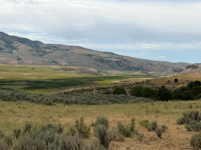Expansive natural landscape featuring rolling hills and varied topography