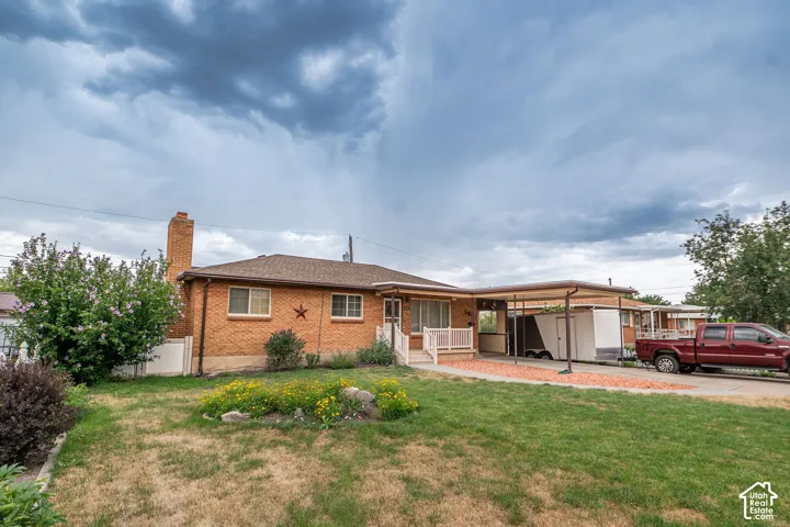 Brick exterior with a covered carport