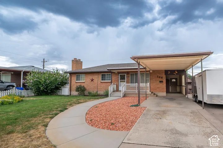 Brick exterior with an attached carport