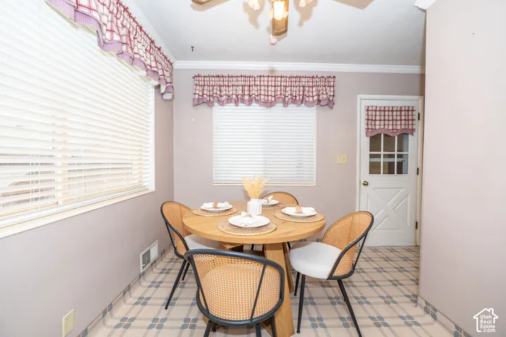 Dining area featuring patterned tile flooring and a white paneled door