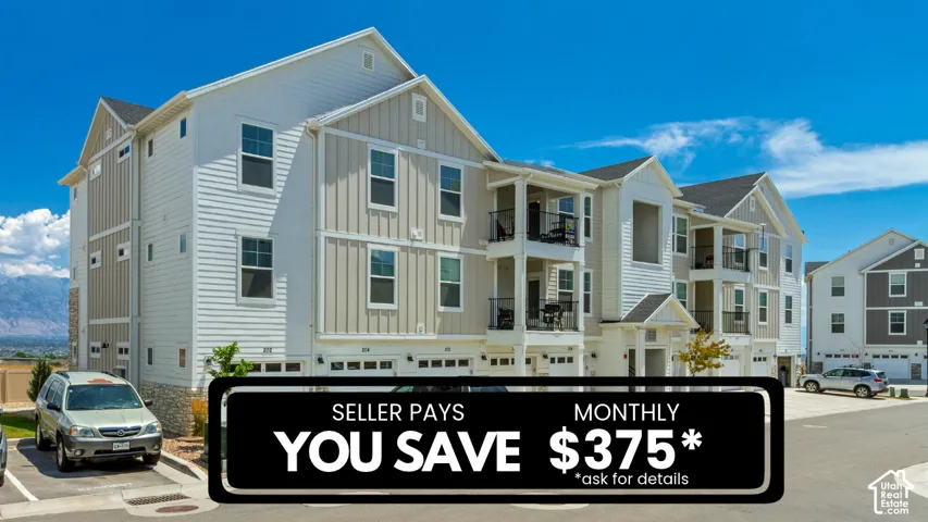 Multi-story building exterior featuring vertical and horizontal siding, stone veneer accents, recessed balconies with metal railings, and attached garage bays