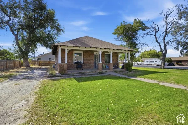 Brick exterior with a covered front porch featuring decorative white columns