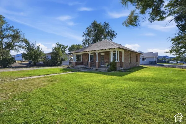 Brick exterior with a covered porch featuring white columns