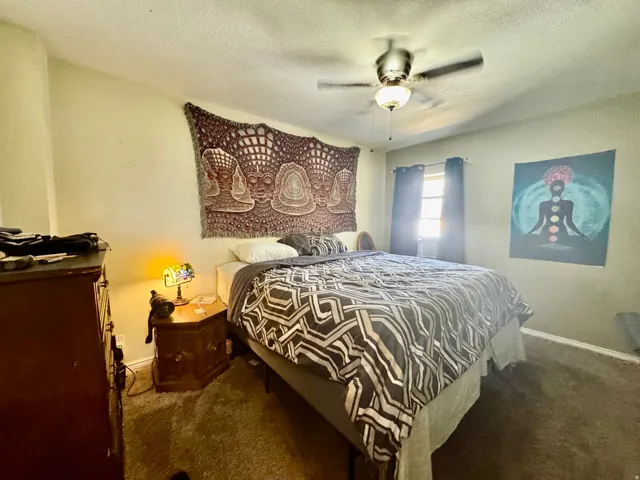 Bedroom featuring carpet flooring and a ceiling fan with integrated lighting