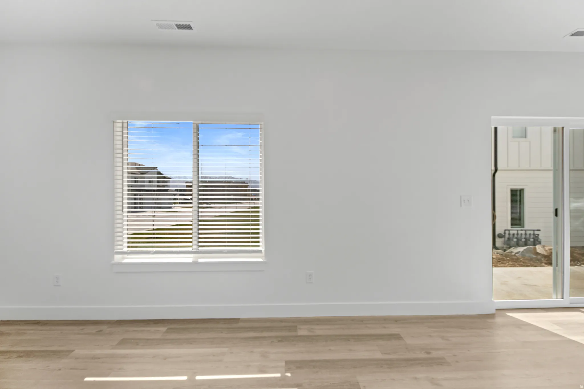 Bright interior space featuring light-toned wood-finish flooring