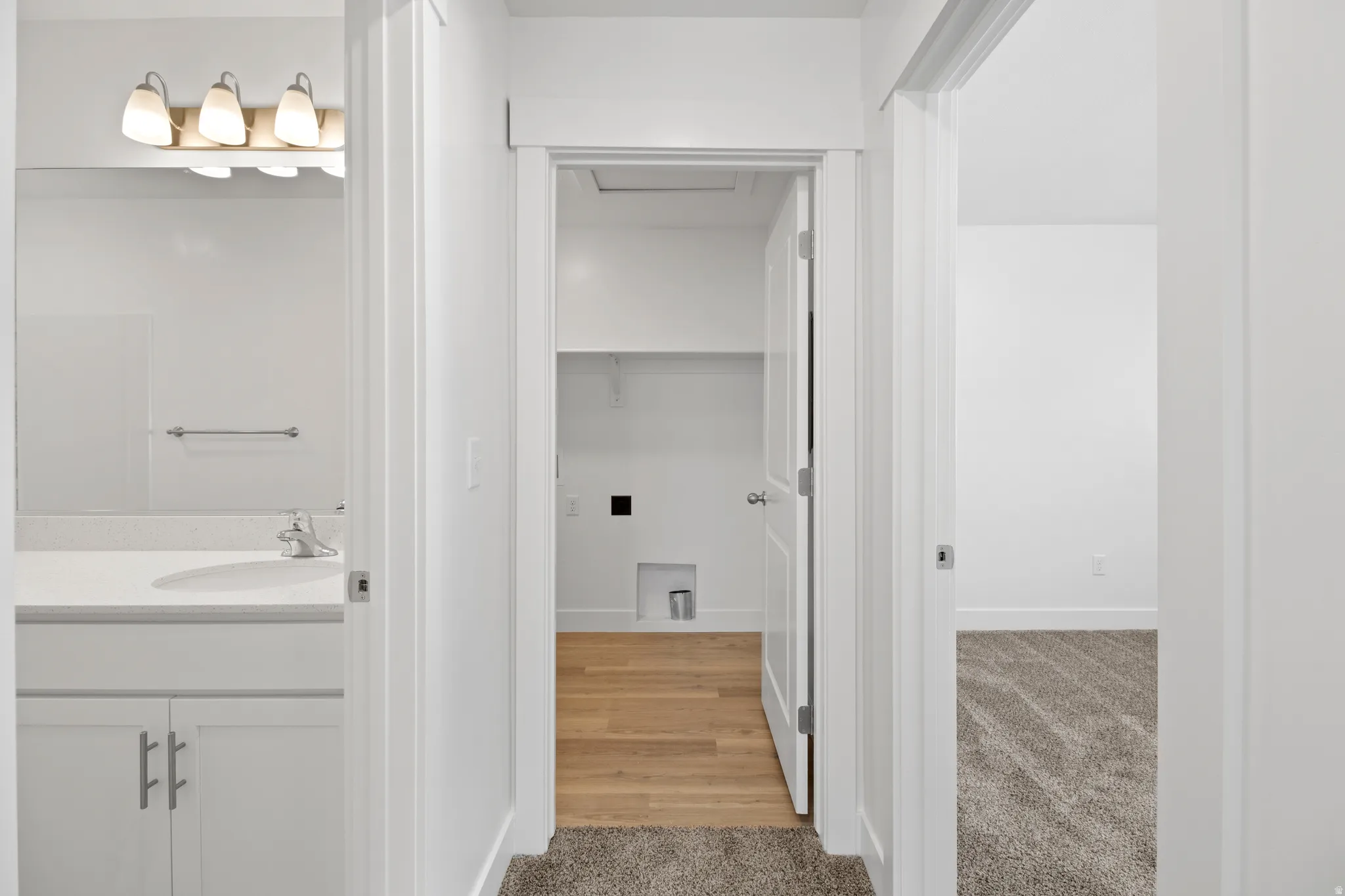 Hallway featuring neutral-toned carpeting