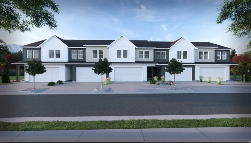 Modern townhome complex featuring a contemporary facade with varying shades of gray and white siding