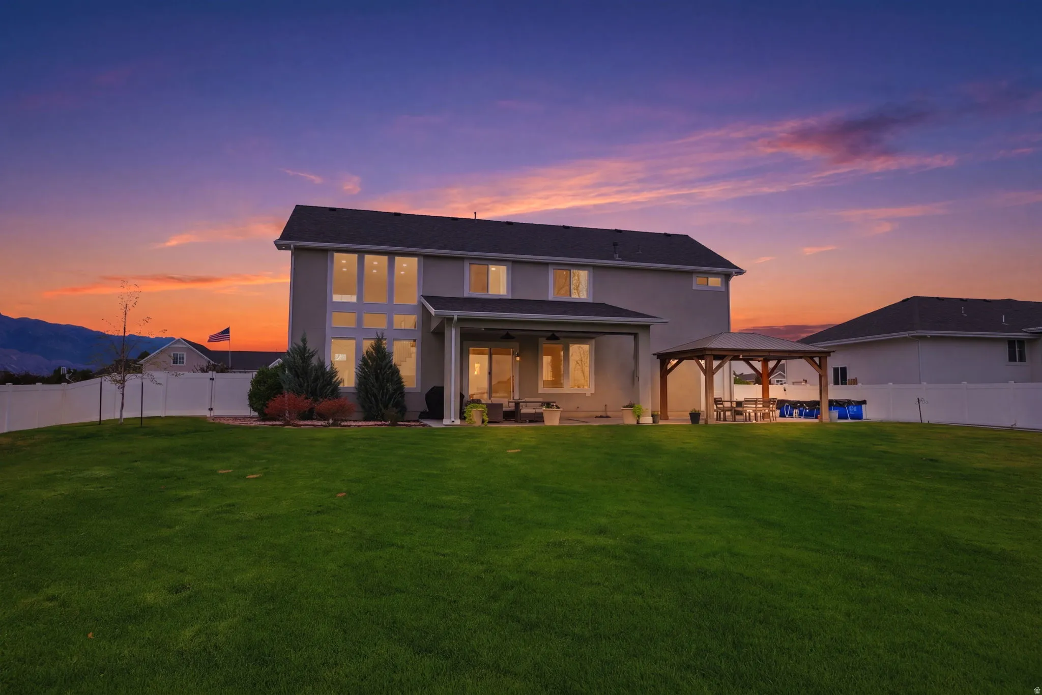 Expansive green lawn with a privacy fence