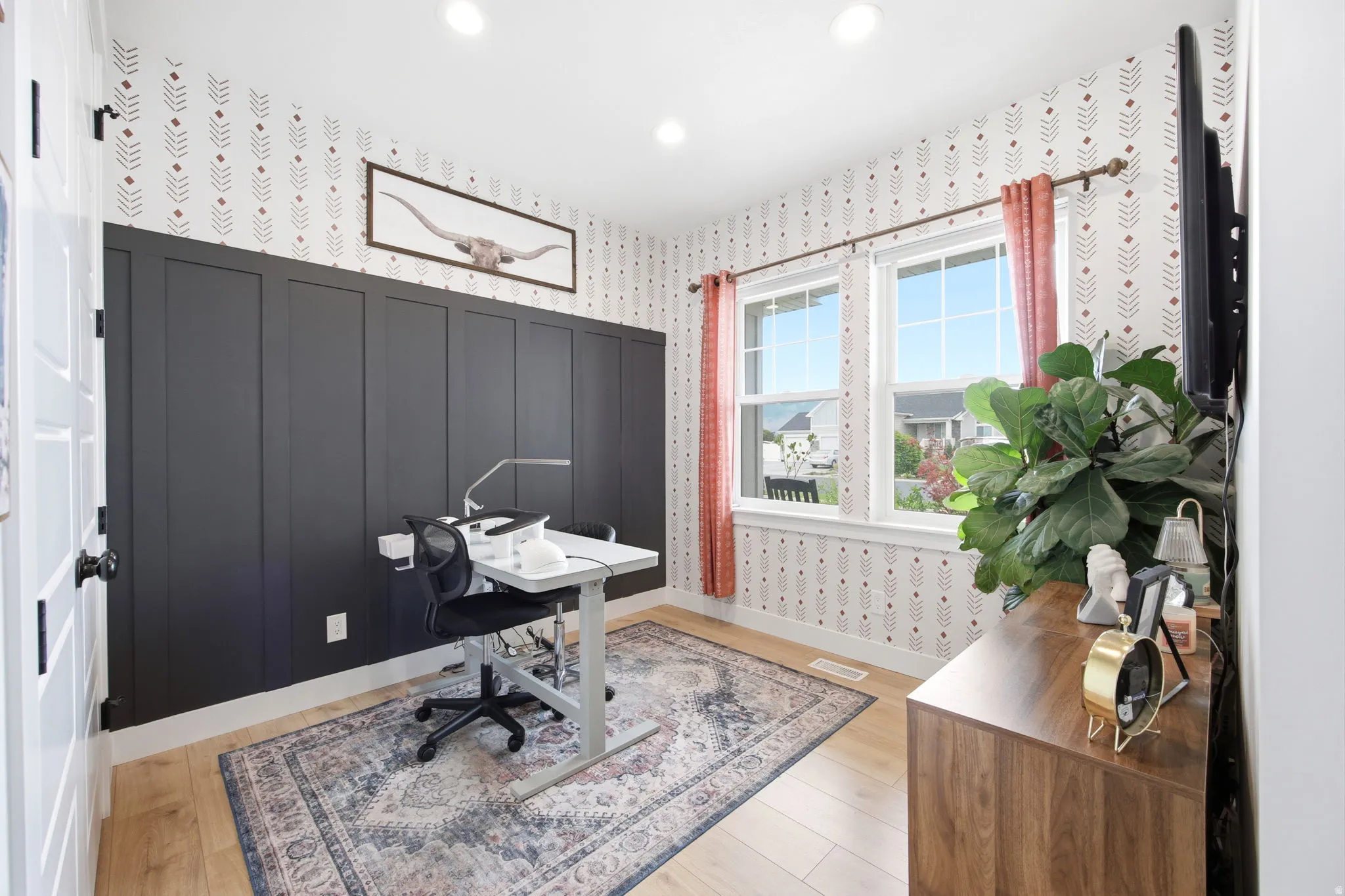 Accent wall with wainscoting and patterned wallpaper
