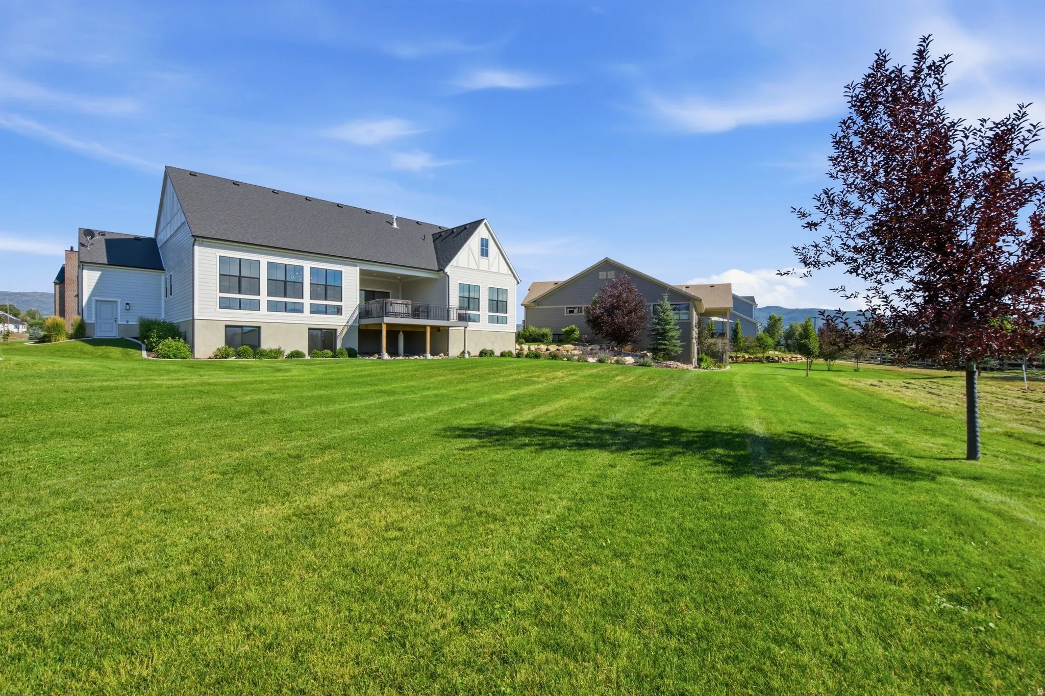 Expansive green lawn with mountain backdrop