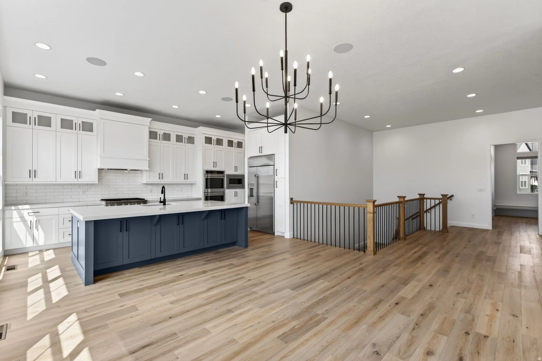Open-concept living space with wide plank wood-finish flooring