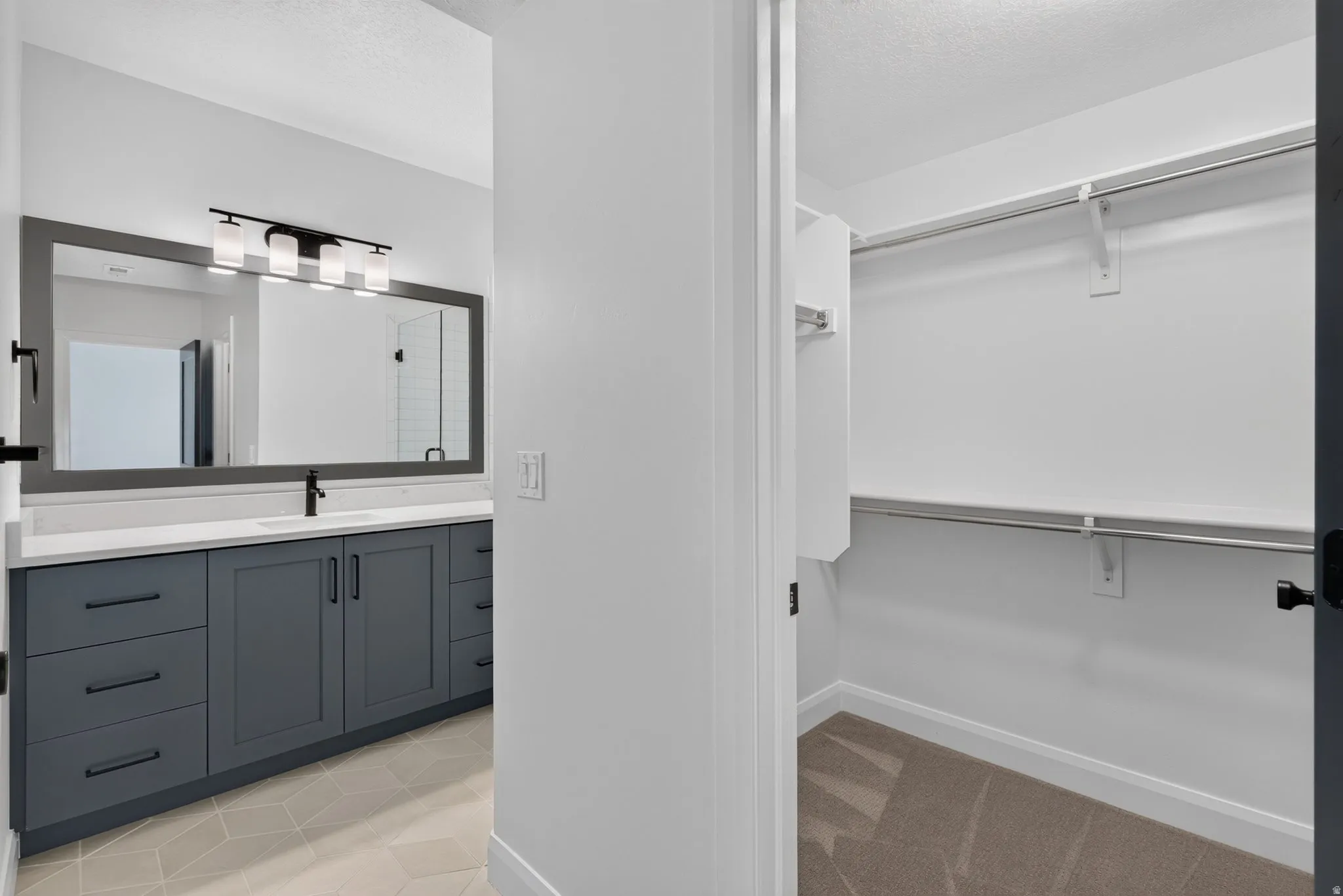 Bathroom vanity with dark gray cabinetry and a white countertop