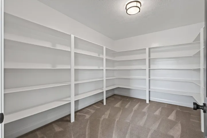 Built-in shelving units, recessed white baseboards, and a semi-flush mount ceiling light