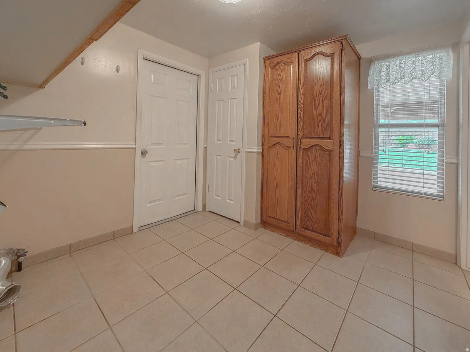 Room with light-colored tile flooring