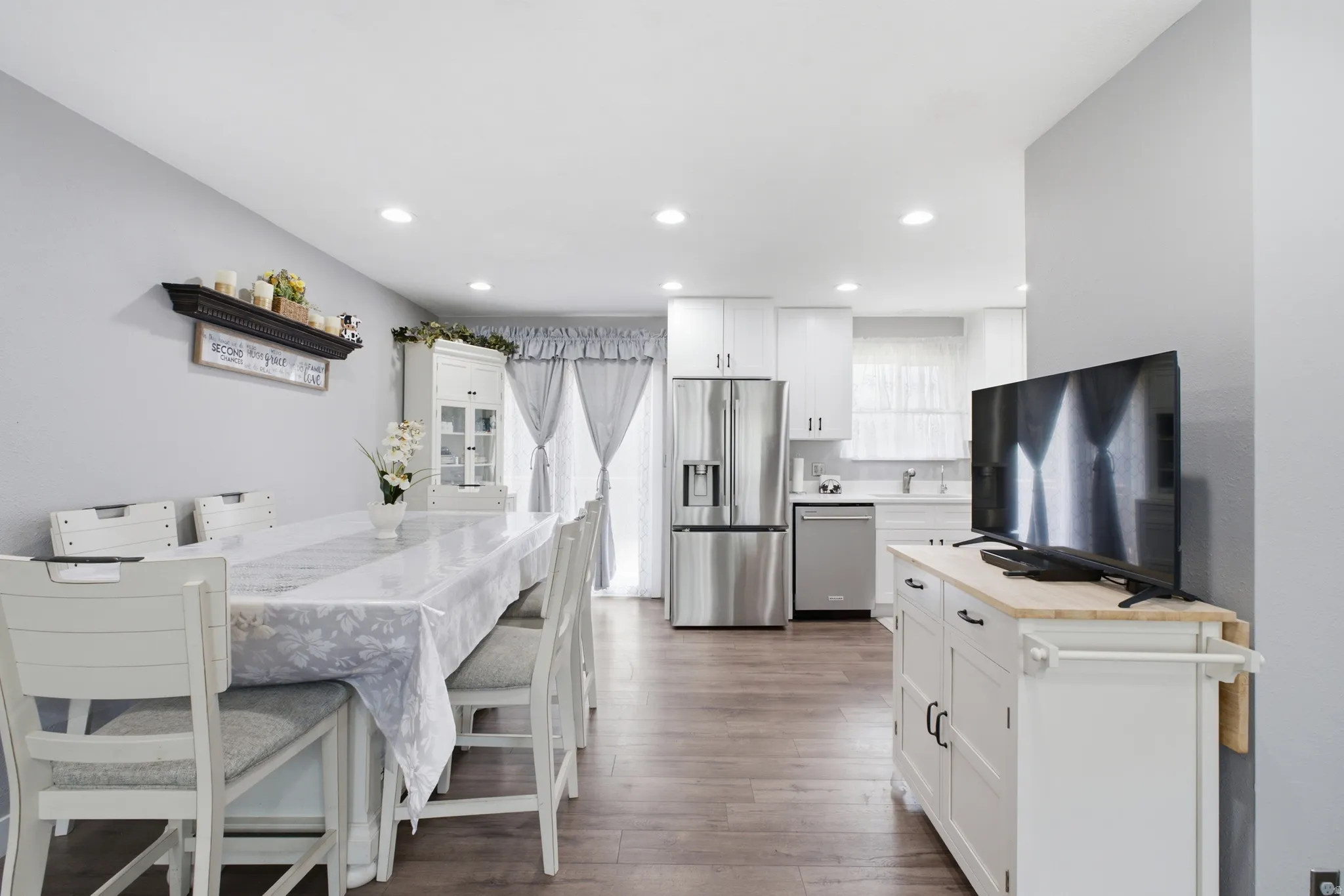 Open-concept living space with recessed lighting and wood-finish flooring