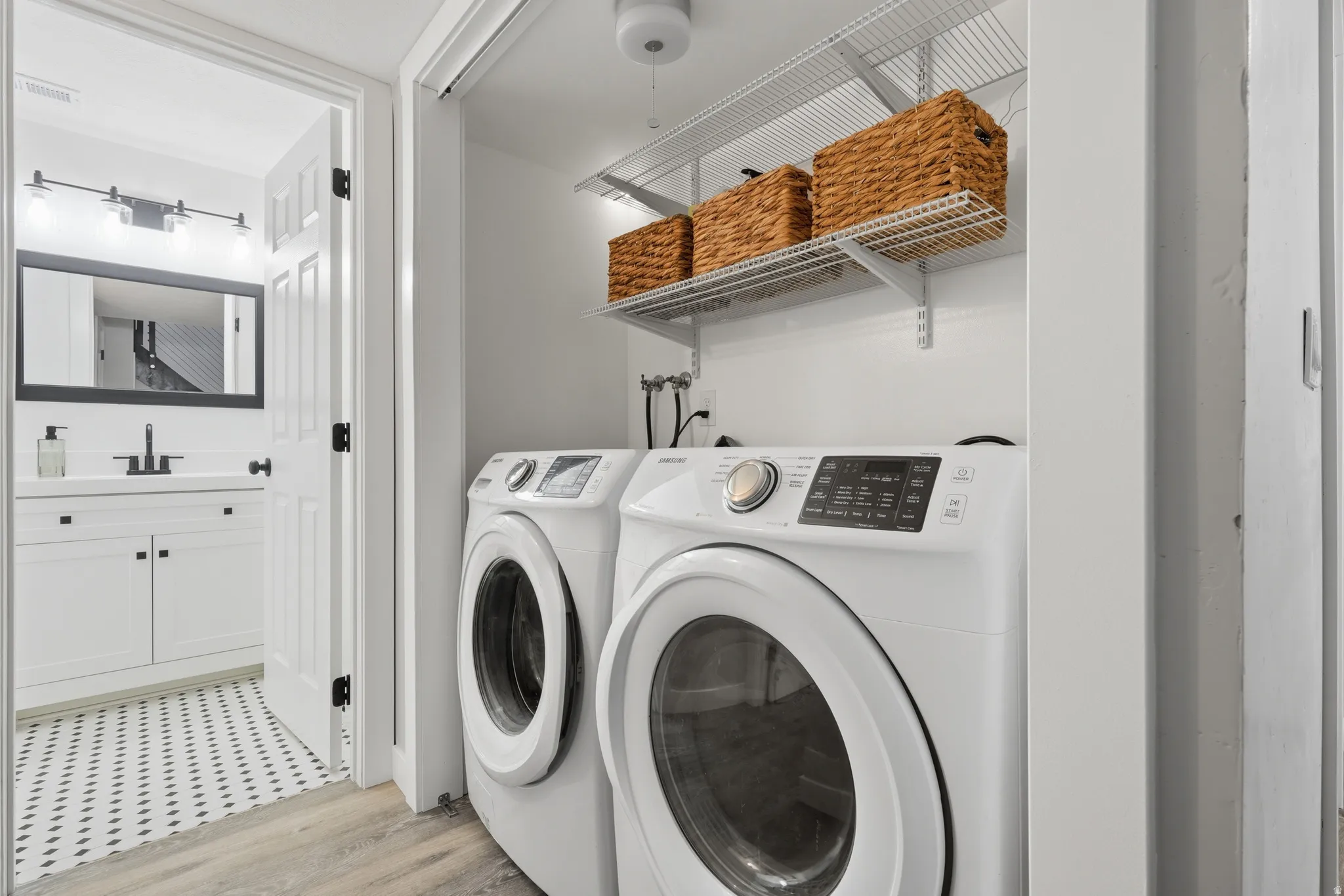 Hallway laundry with view into the full bathroom.