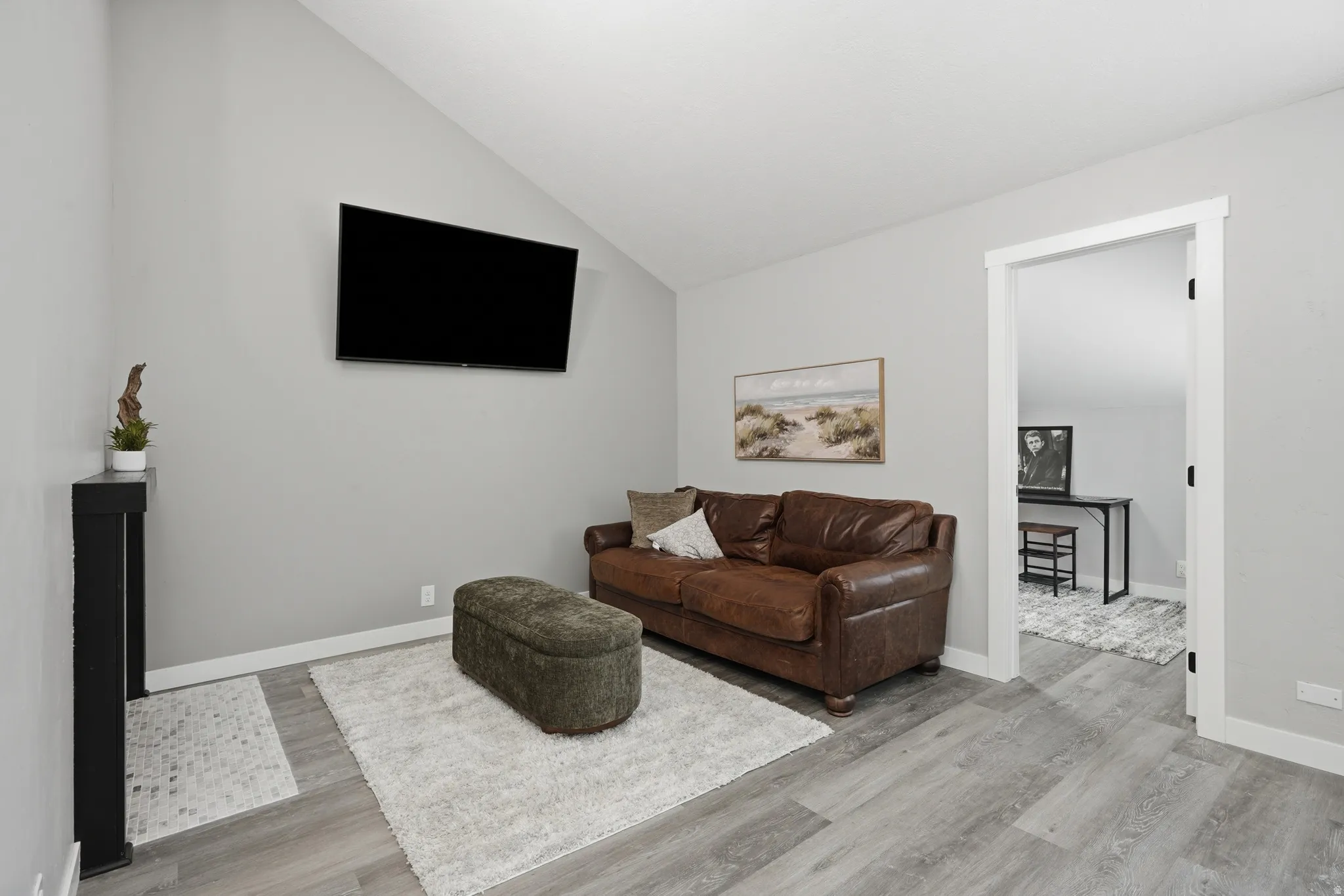 Living room with view to door of den.