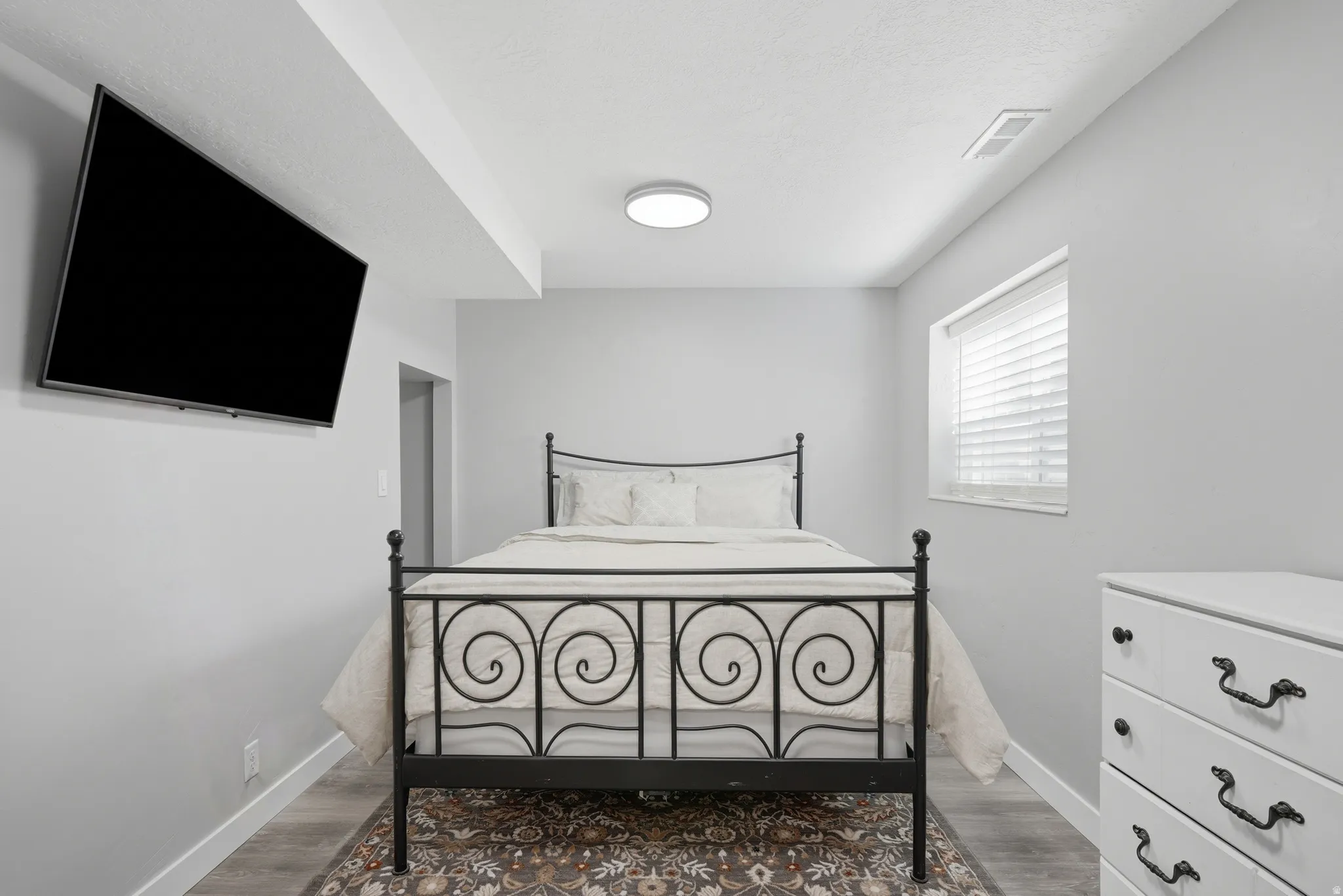 Primary bedroom with view of extra storage space to the left
