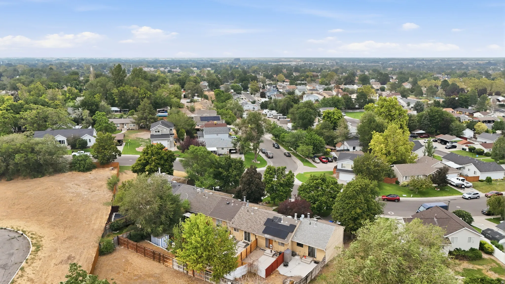 View of back of home and community area behind back fence.