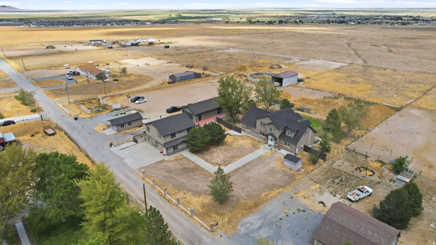 Property featuring multiple residential structures, detached garages, and outbuildings