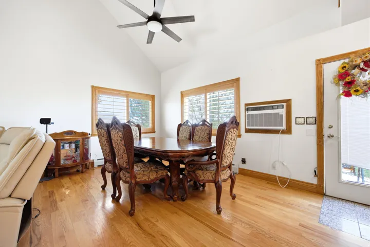 Main home - Vaulted ceilings highlight this space featuring wood-finish flooring and natural wood window trim