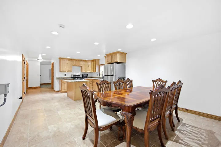 Main home - Basement with kitchen - Open-concept living area with tile flooring and recessed lighting