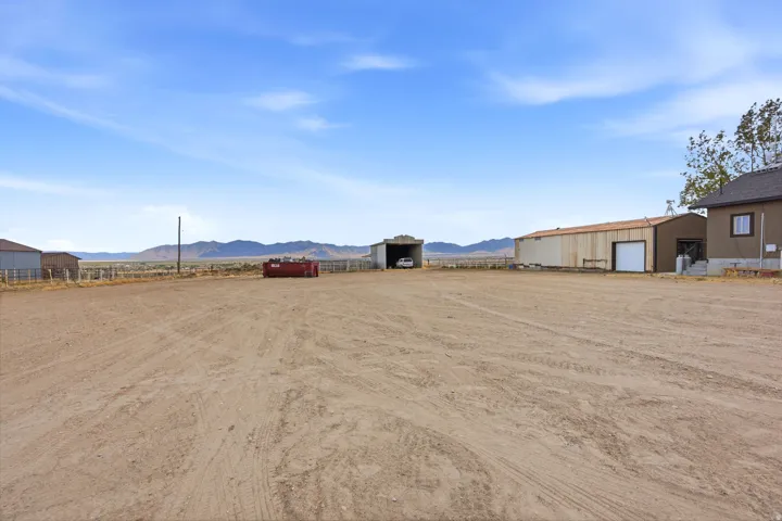 Expansive open lot featuring a detached 2 car garage with a large shed behind the garage and an additional outbuilding.