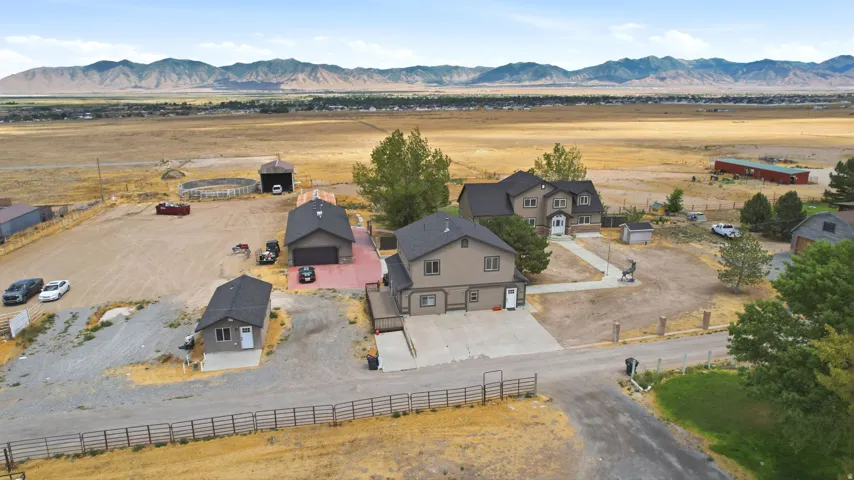 Expansive property featuring two residences, a detached garage, and a smaller outbuilding