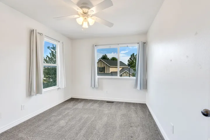 Room featuring light gray carpet flooring, white painted walls, and white trim