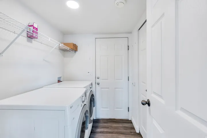 Dedicated laundry area featuring wire shelving for storage