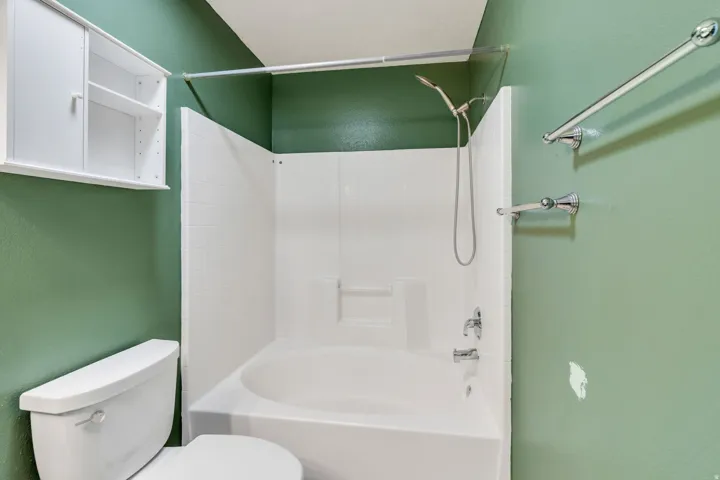 White bath/shower combination with a handheld showerhead