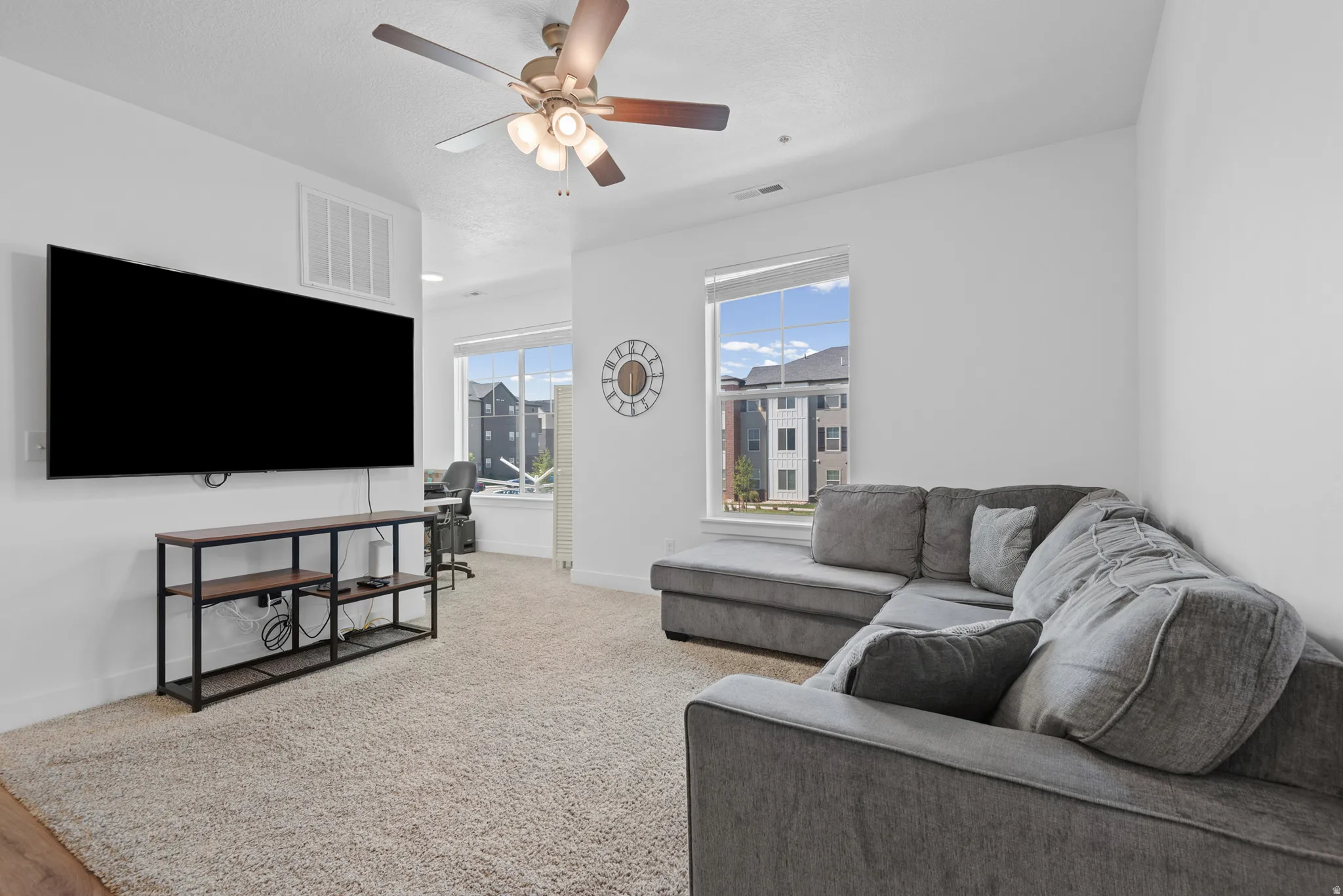 Bright interior space with carpet flooring and white walls