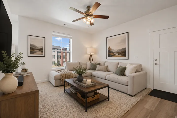 Recessed lighting, wood-finish flooring, and a ceiling fan with integrated lighting