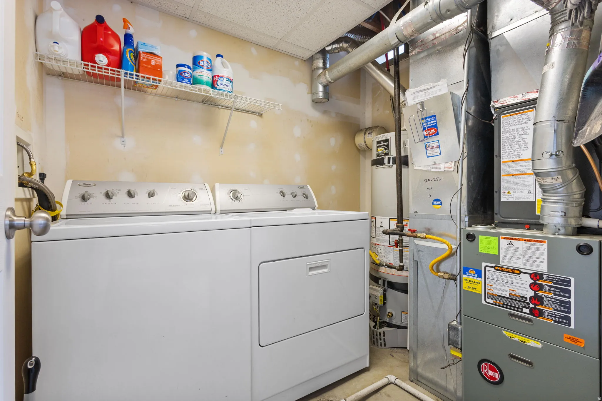 Dedicated utility area featuring a washer and dryer, water heater, and furnace