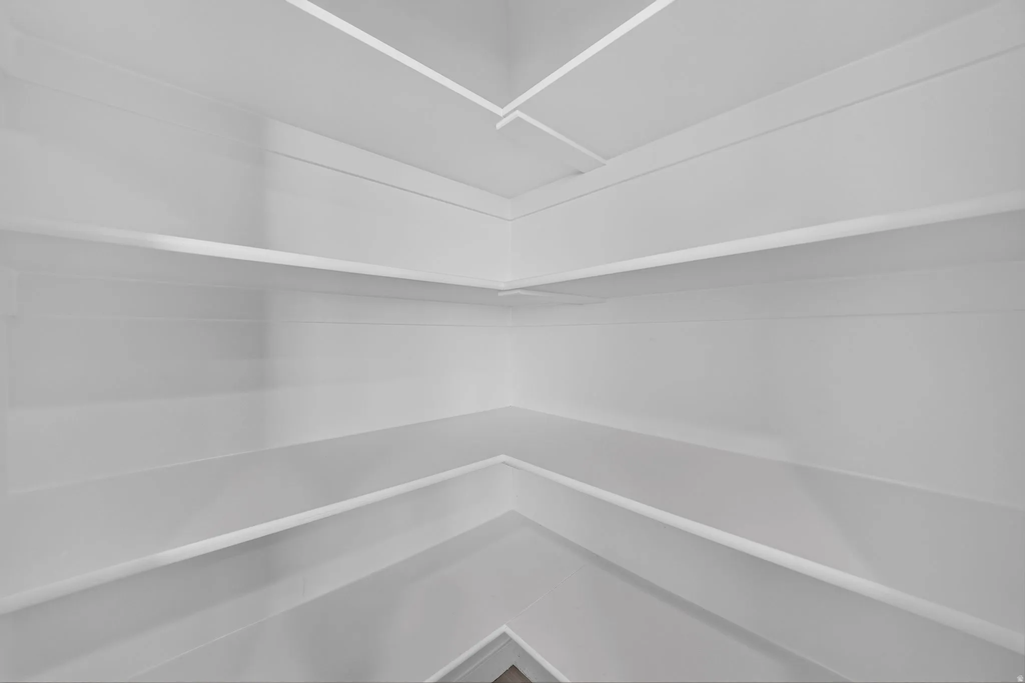 Corner shelving system featuring multiple white shelves