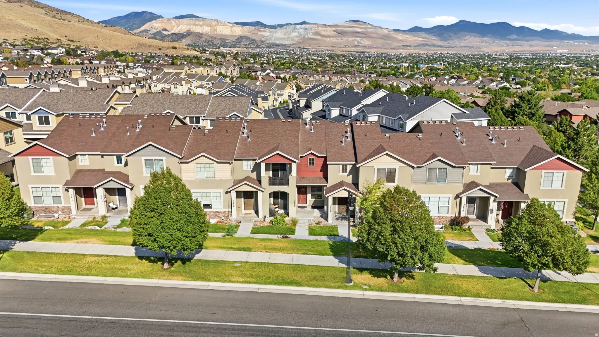 Townhome row featuring diverse exterior color palettes and architectural elements