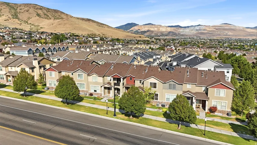 Residential development featuring multi-level townhomes with mixed-material facades and pitched roofs