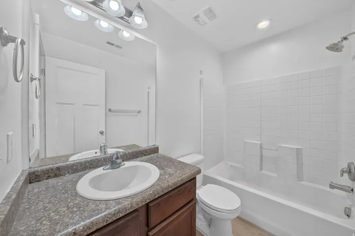Bathroom with a wood-finish vanity and integrated sink