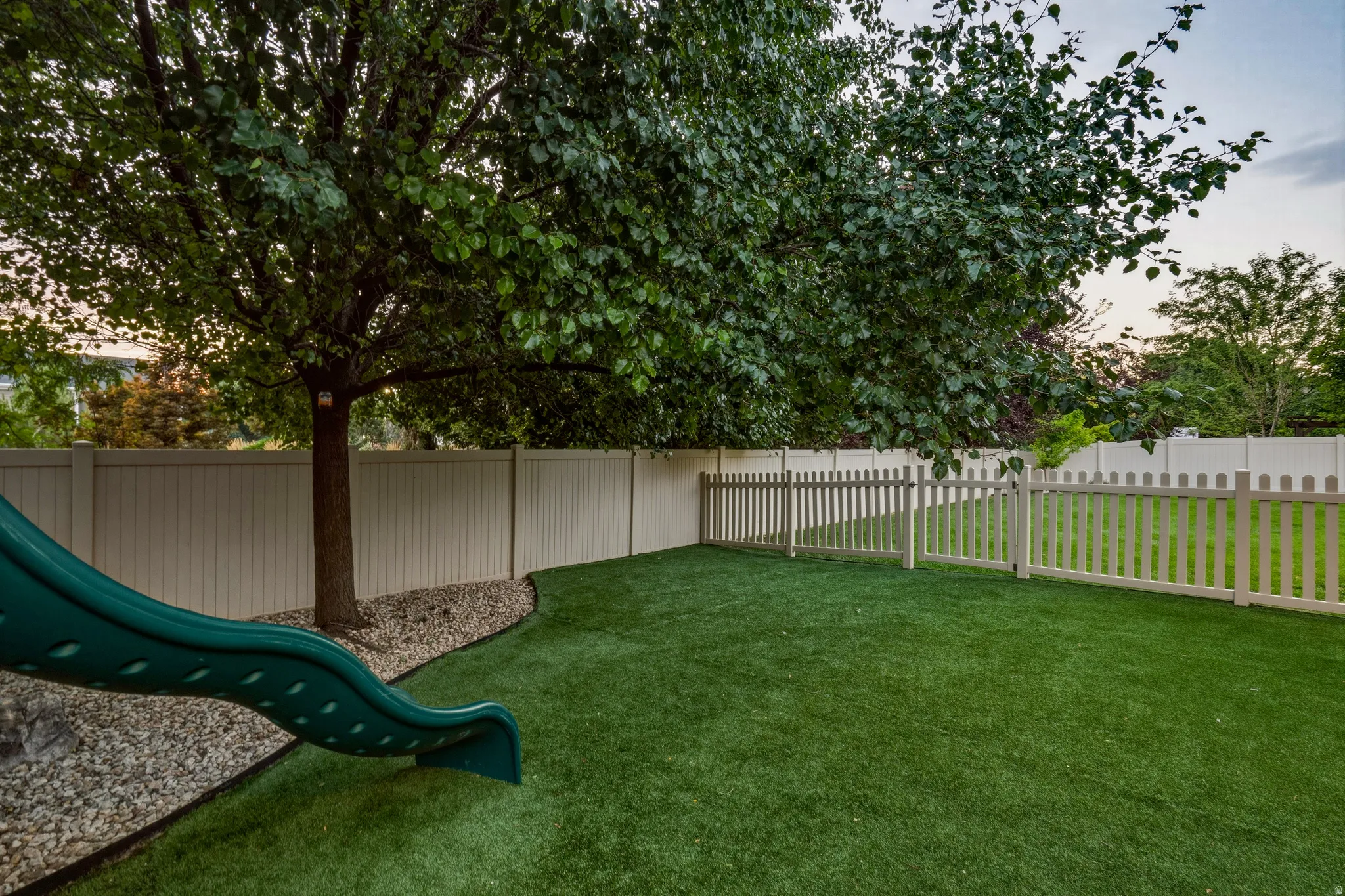 Backyard has Divider Fence for Pet Separation from Playground