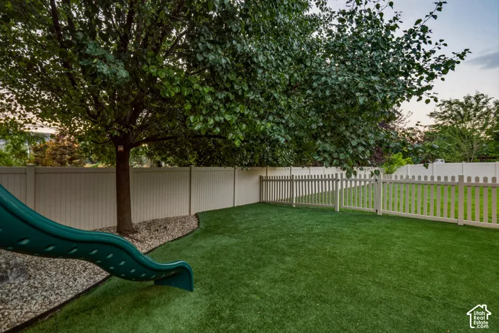 Backyard has Divider Fence for Pet Separation from Playground