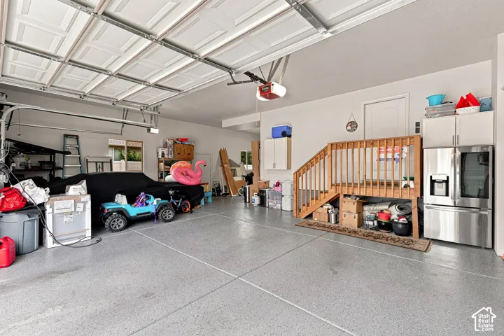 NEW Epoxy Floor, Finished and Painted Walls, NEW Metal Attached Storage Shelves, 2 EV Charging  Outlets, Wifi Garage Openers