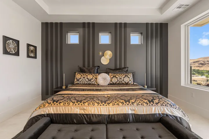 Tray ceiling with recessed lighting in primary bedroom